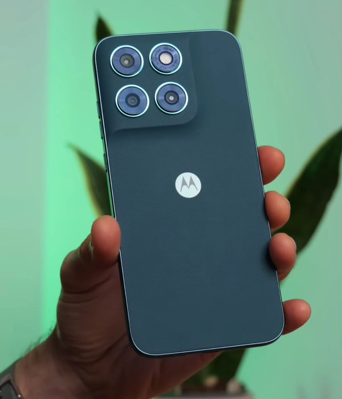 Motorola G77 smartphone held in hand showcasing its camera design and logo.