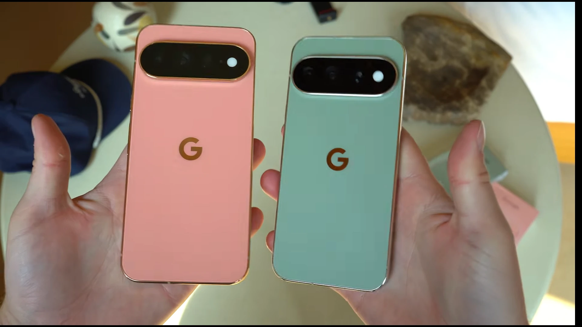 Comparison of Google Pixel 11 Pro and Pixel 11 Pro XL smartphones in pink and green colors.