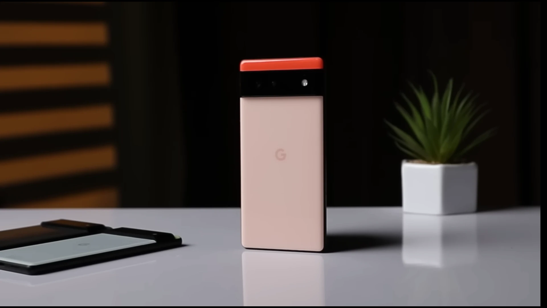 Google Pixel 6 smartphone in a minimalist setup with a plant and a tablet
